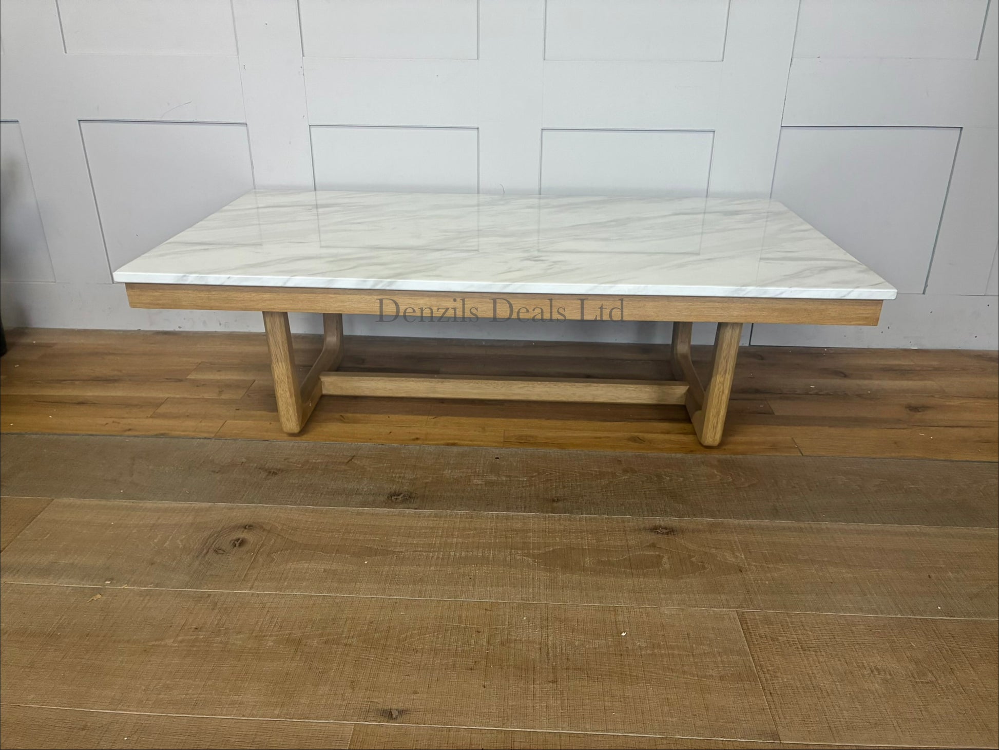 Nick Scali Carlina coffee table featuring a rectangular white marble top and a warm-toned solid wood apron with sleek rounded timber legs."