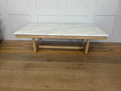 Nick Scali Carlina coffee table featuring a rectangular white marble top and a warm-toned solid wood apron with sleek rounded timber legs."