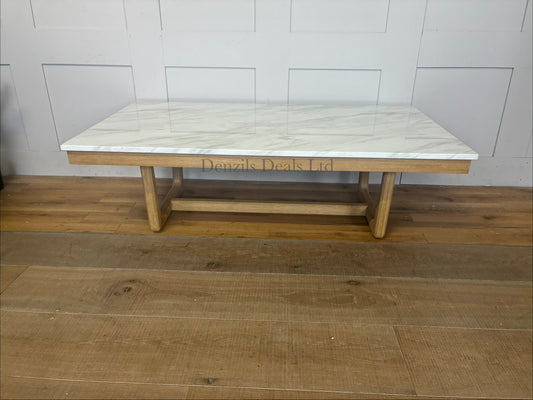 Nick Scali Carlina coffee table featuring a rectangular white marble top and a warm-toned solid wood apron with sleek rounded timber legs."