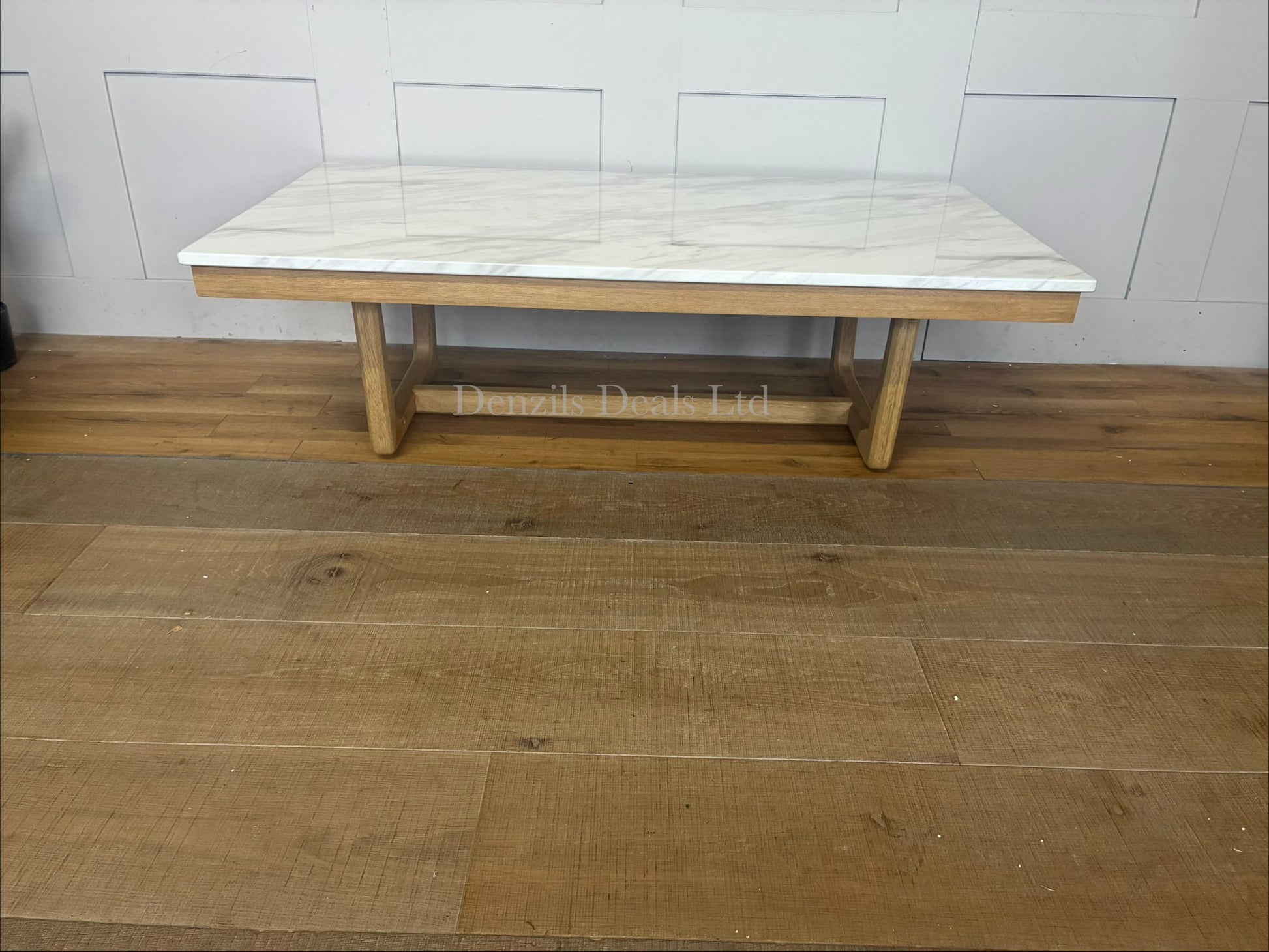 Nick Scali Carlina coffee table featuring a rectangular white marble top and a warm-toned solid wood apron with sleek rounded timber legs."