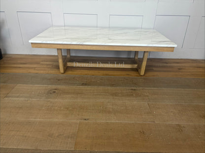 Nick Scali Carlina coffee table featuring a rectangular white marble top and a warm-toned solid wood apron with sleek rounded timber legs."