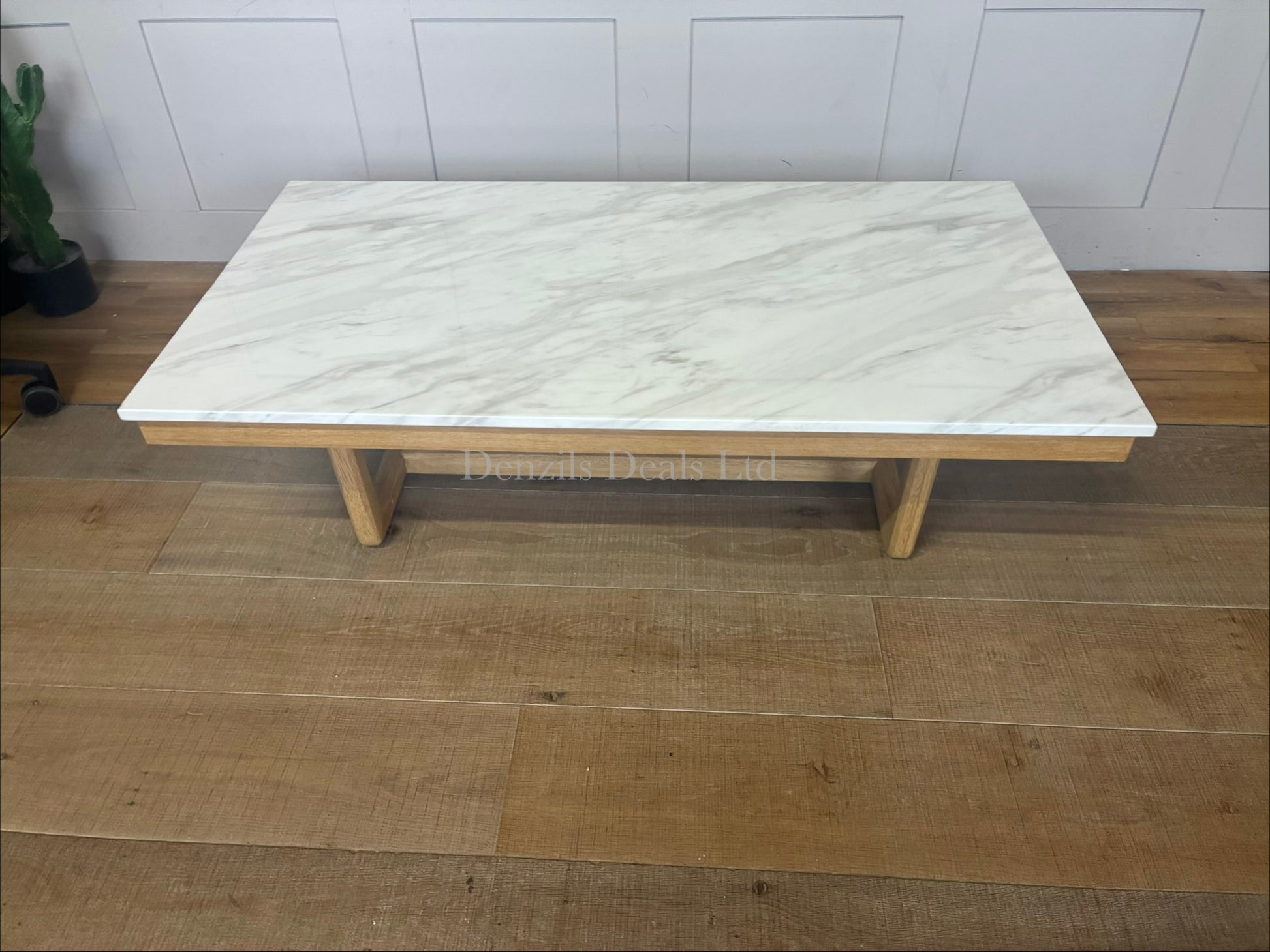 Nick Scali Carlina marble coffee table placed in a modern living room, styled with a solid timber frame and warm wood apron."