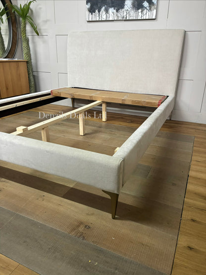 Nontufted West Elm Andes king-size bed upholstered in sand-colored fabric, supported by champagne bronze metal legs.