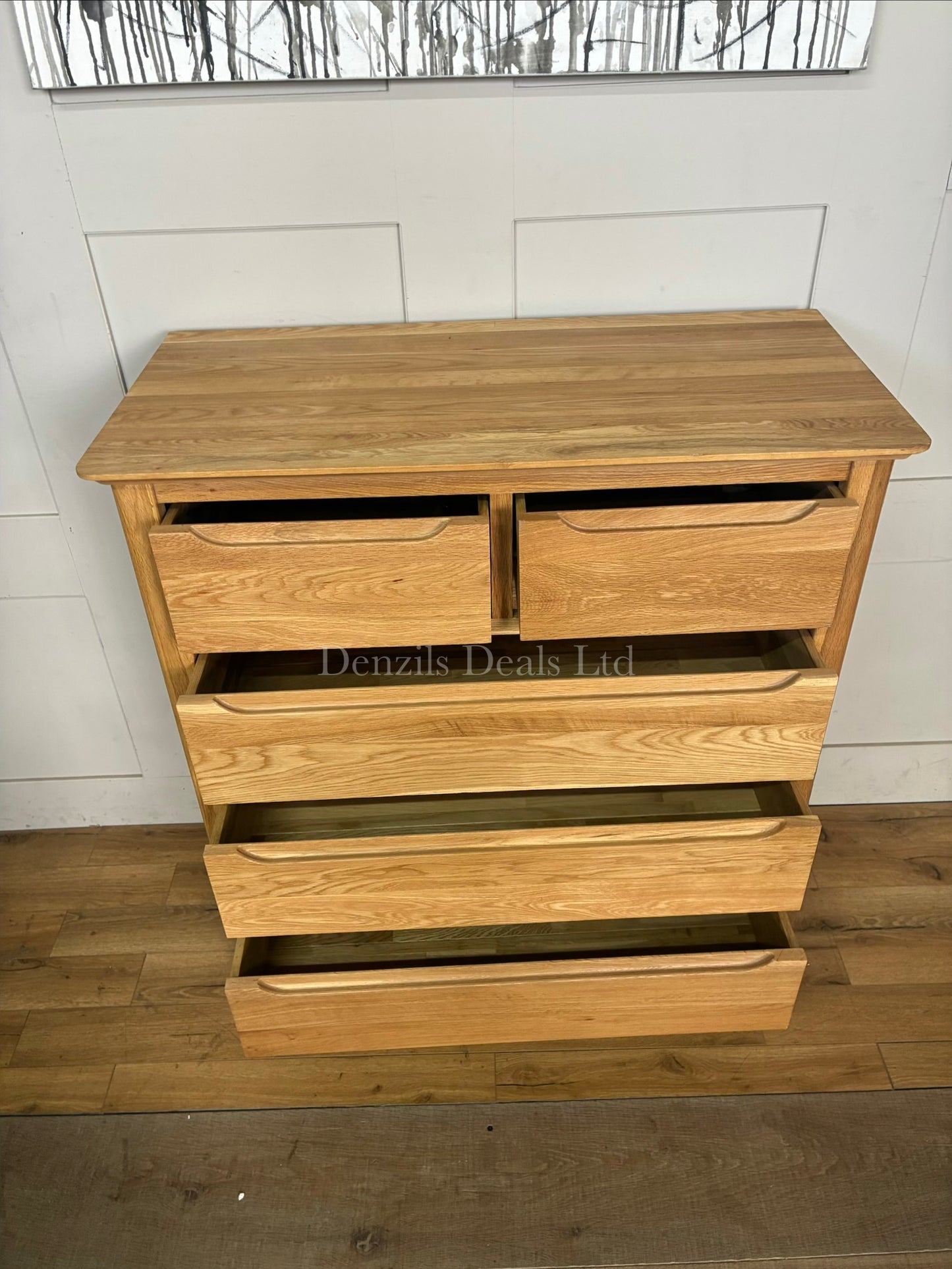 Oak Furnitureland Copenhagen 5-drawer chest in natural solid oak with a blonde wax finish and recessed handles.