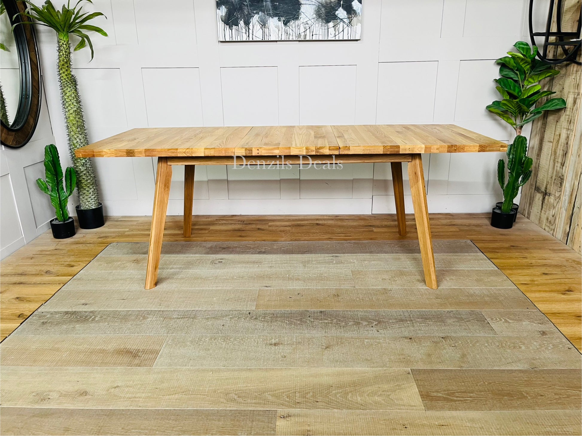 Oaklee 6-8 seater extendable dining table in solid natural oak with splayed legs.