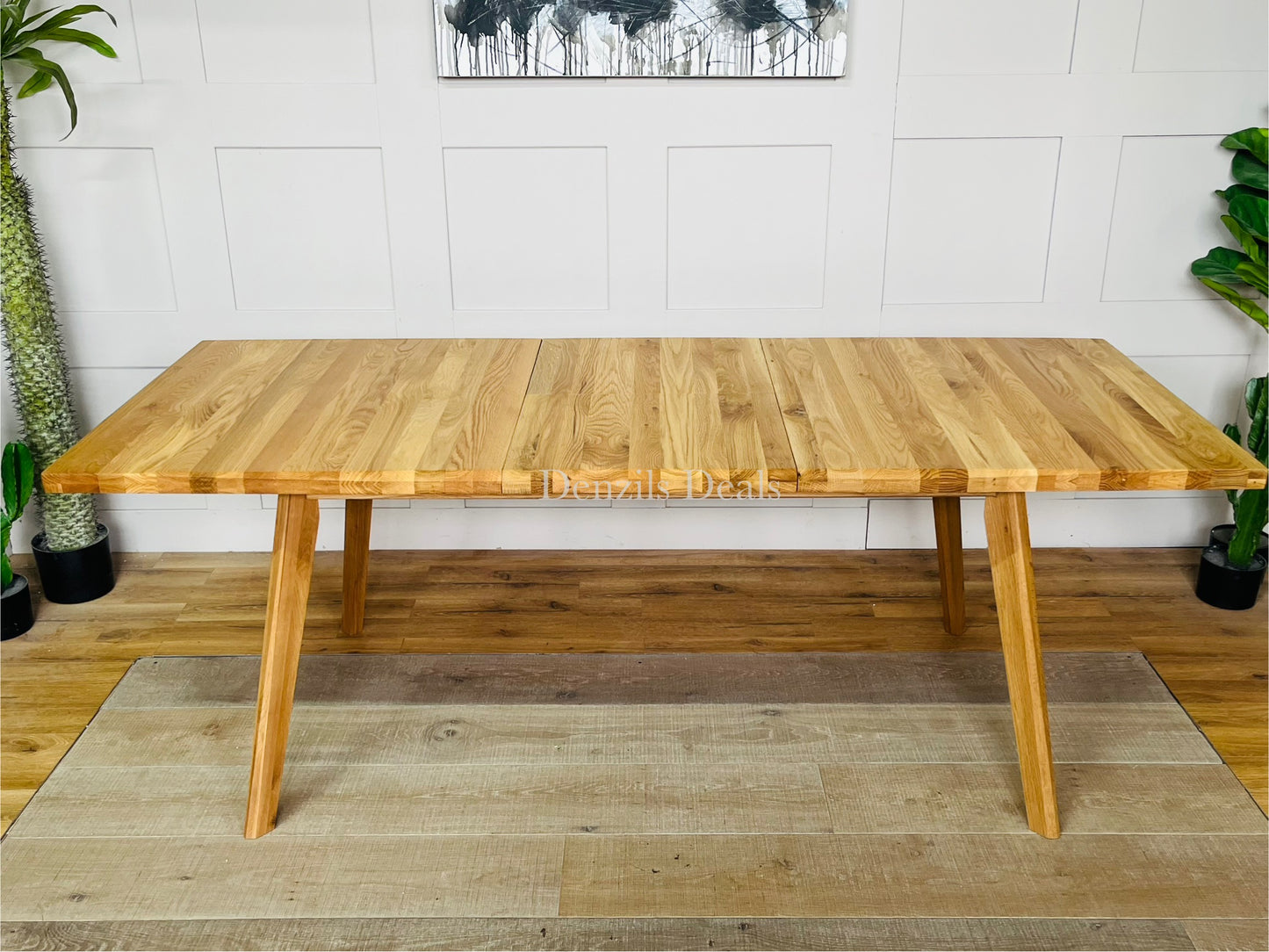 Oaklee natural oak dining table shown with central butterfly extension mechanism partially opened.