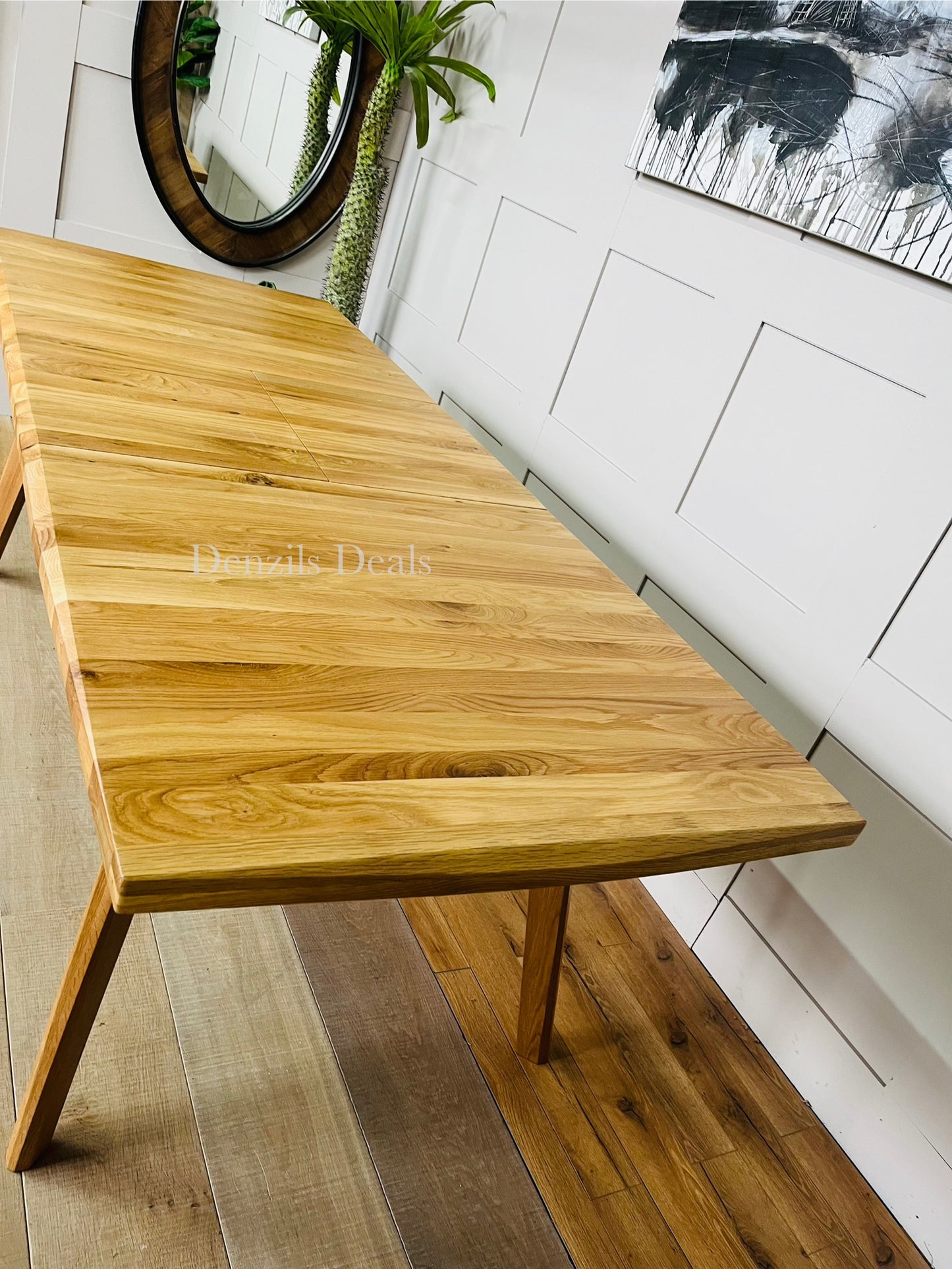 Oaklee natural oak table fully extended with butterfly mechanism, seats eight people.