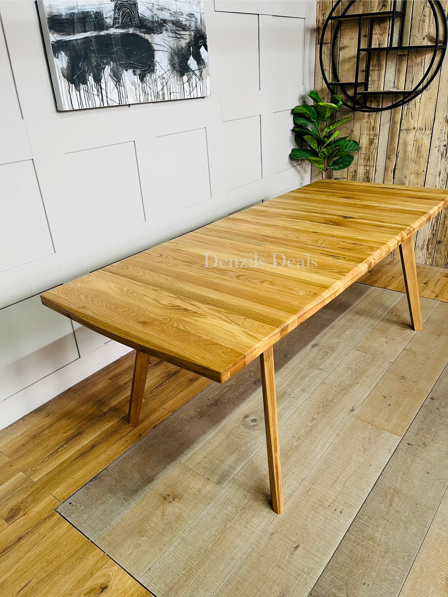 Oaklee natural oak table fully extended with butterfly mechanism, seats eight people.