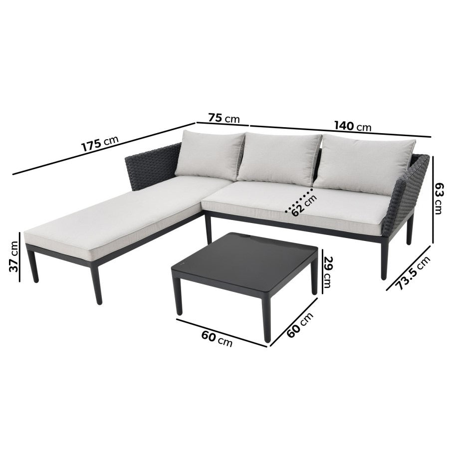 Outdoor black wicker L-shaped sofa with a chaise longue, beige cushions, and a matching coffee table set on a garden patio.