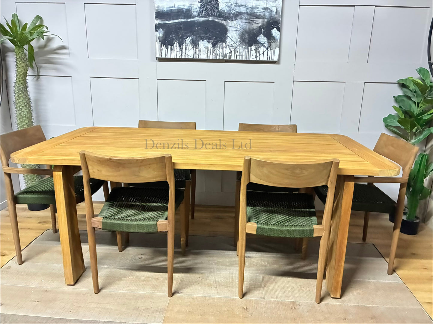 John Lewis Outdoor dining set featuring a contemporary rectangular table and six matching Scandi-style dining chairs, arranged on a sunny patio. The natural teak wood furniture features smooth, rounded corners and modern, blocky, upholstered seating with shower-resistant cushions."