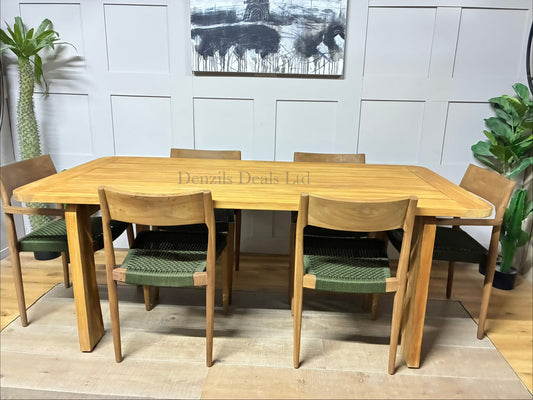 John Lewis Outdoor dining set featuring a contemporary rectangular table and six matching Scandi-style dining chairs, arranged on a sunny patio. The natural teak wood furniture features smooth, rounded corners and modern, blocky, upholstered seating with shower-resistant cushions."