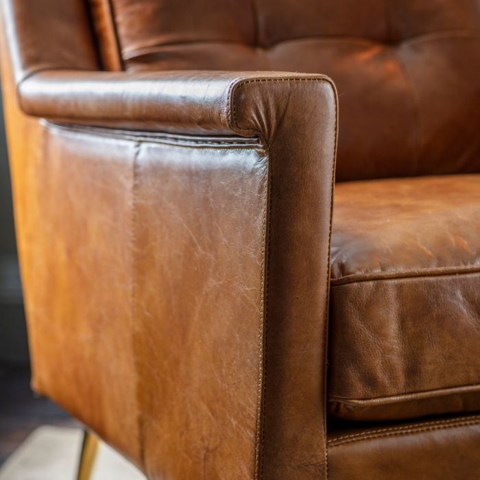 Pavilion Chic Saltford armchair in vintage brown leather with button detailing and slender gold metal legs"