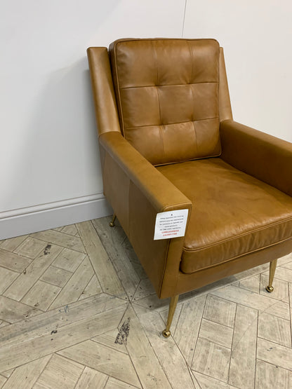 Mid-century style brown leather armchair with buttoned back and polished gold legs"