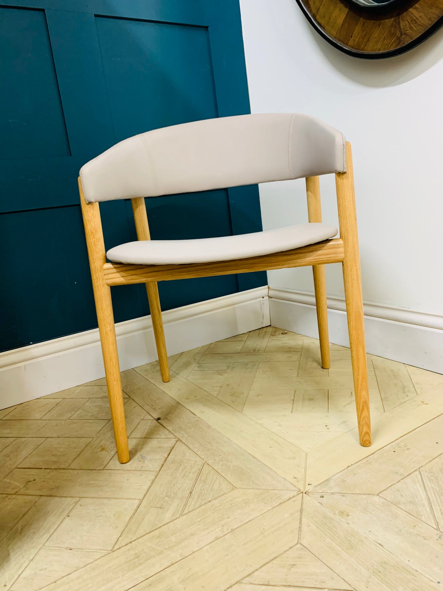 Protocol Camille 986 armchair featuring a curved wooden back and minimalist aesthetic."