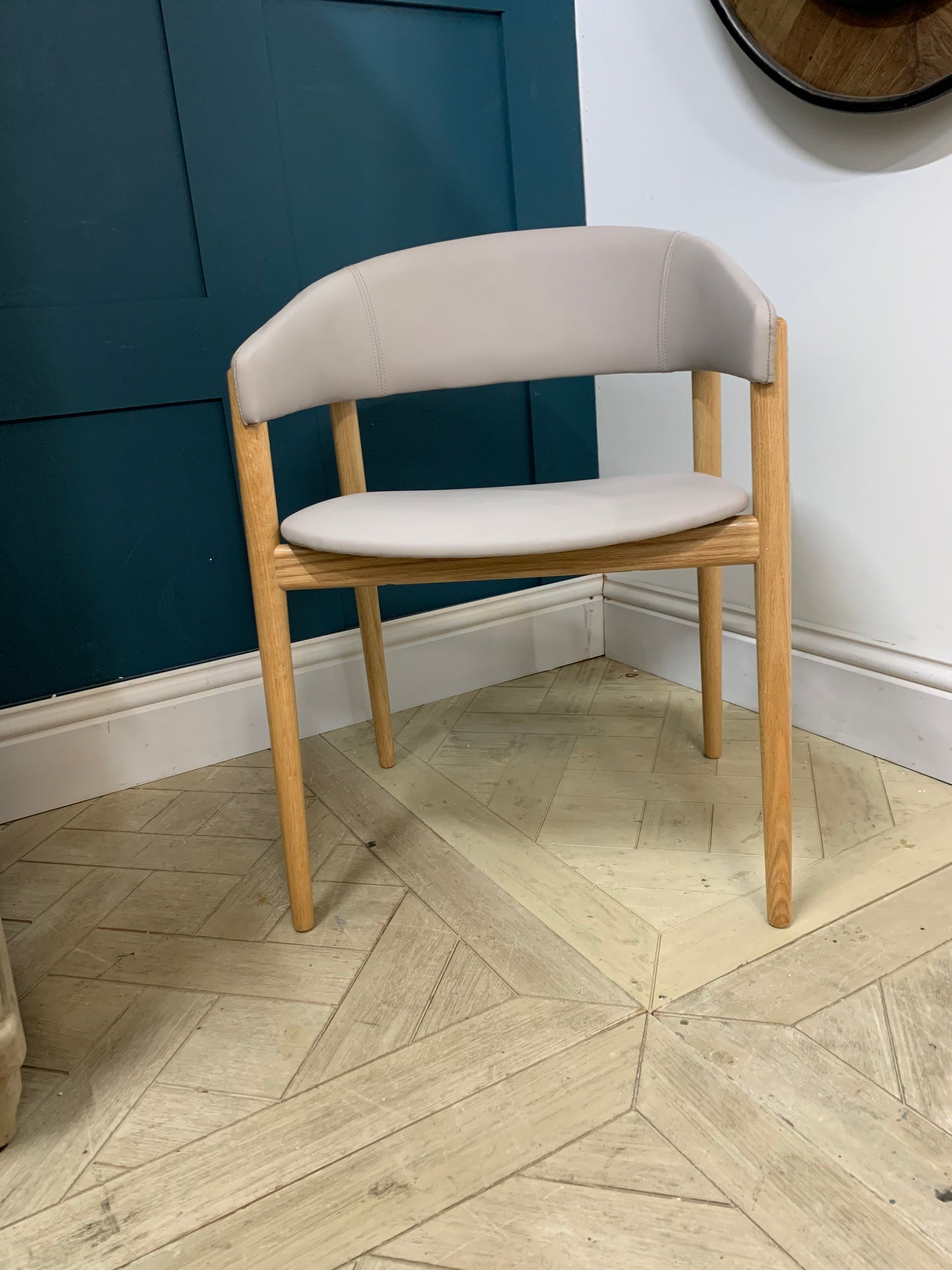 Protocol Camille 986 armchair featuring a curved wooden back and minimalist aesthetic.