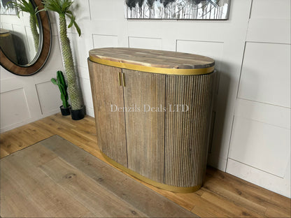 RV Astley Maigue Oval Bar Cabinet featuring a fluted, rich brown wood body, antique brass handles, a matching brass base trim, and a neutral wooden top.