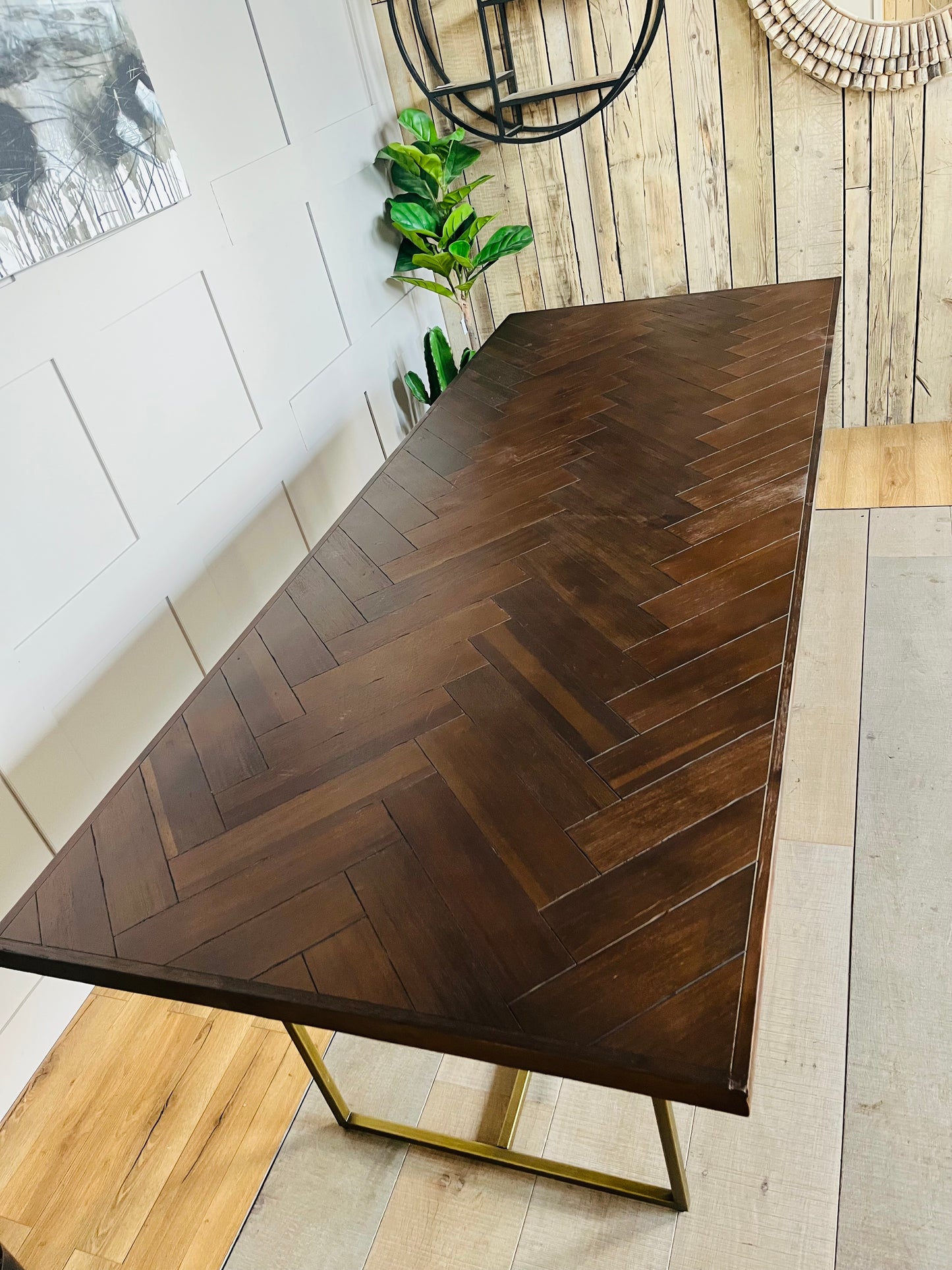 Rectangular Dutchbone Class 220cm dining table featuring a rich dark brown acacia wood top with an intricate herringbone pattern and a contrasting geometric brass-coated metal base.