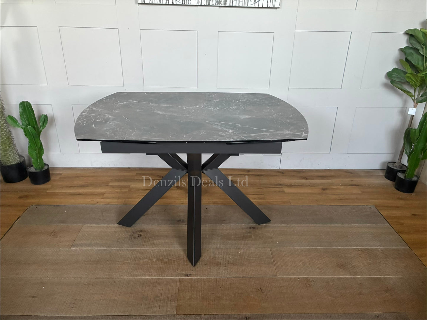 Rhodes Twist Top Extending Dining Table with a printed glass HPL (High-Pressure Laminate) finish. Contemporary twist-top expanding mechanism where the central section rotates or slides open to reveal extra surface area.