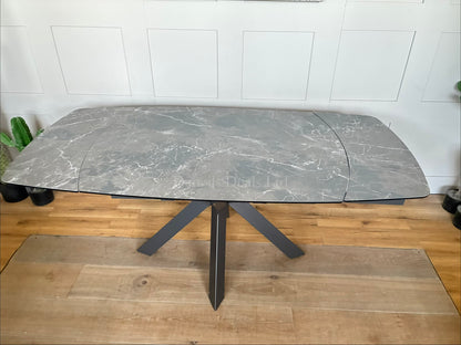 Rhodes Twist Top Extending Dining Table . The table surface smoothly rotates to automatically activate the extension panels, eliminating the need to store heavy loose leaves