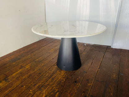 Richmond Degas 120cm round dining table featuring a sleek, smooth white faux marble top resting on a bold, conical matte black metal pedestal base