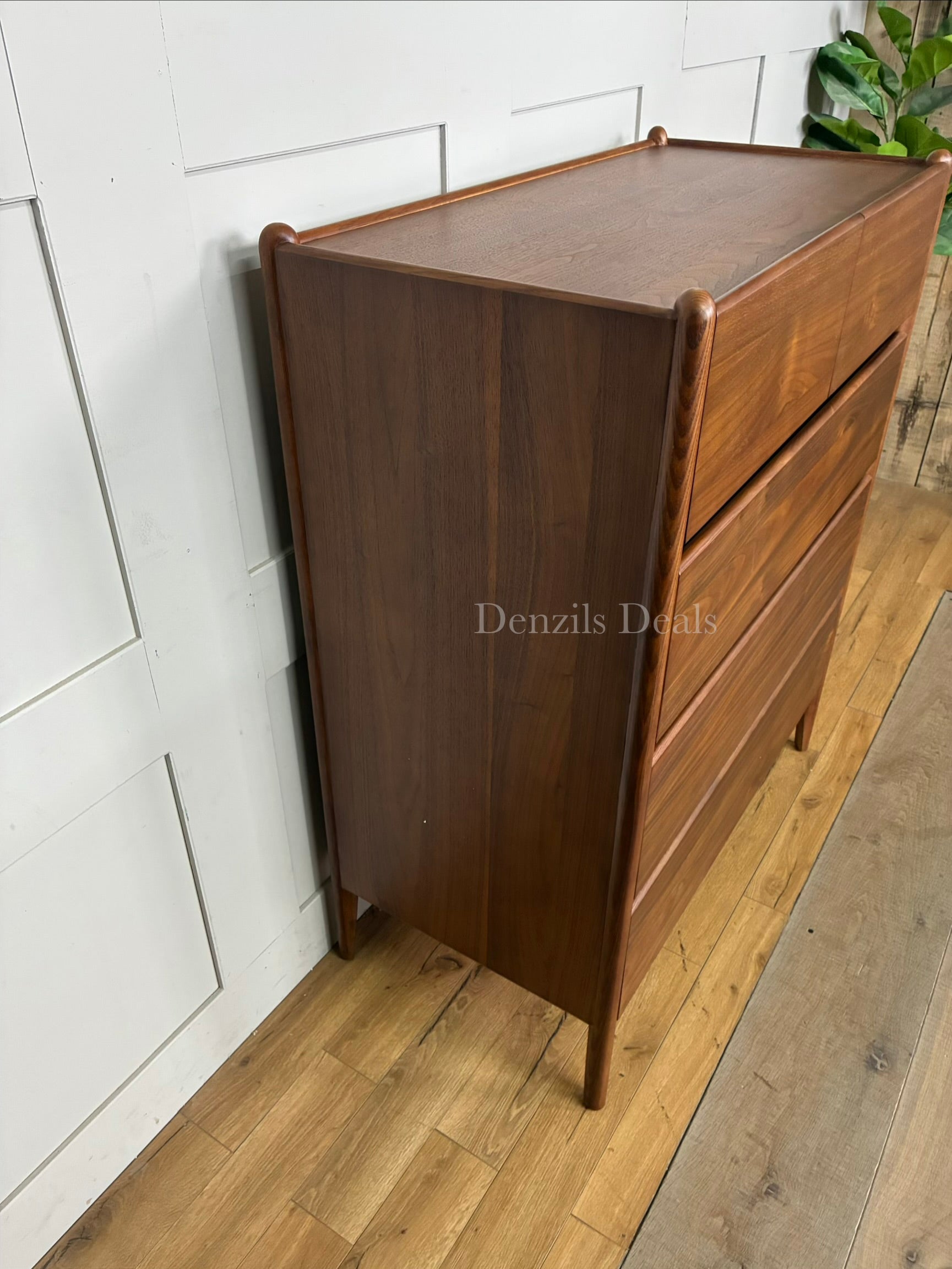 John Lewis Scandi 5 Drawer Wood Chest, Walnut Finish with five storage drawers and the top surface has a slight tray-edge design so your bedside essentials stay secure. Rounded posts, tapered legs and sleek, handle-less drawers all honour Scandinavian design principles, so it's perfect for keeping your bedroom a calm, uncluttered and simple space.
