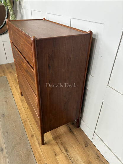John Lewis Scandi 5 Drawer Wood Chest, Walnut Finish with five storage drawers and the top surface has a slight tray-edge design so your bedside essentials stay secure. Rounded posts, tapered legs and sleek, handle-less drawers all honour Scandinavian design principles, so it's perfect for keeping your bedroom a calm, uncluttered and simple space.