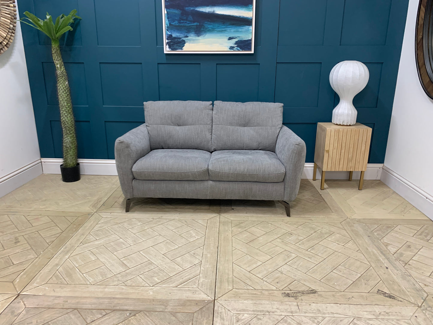 Side profile of the Sofology Mimi 2 seater sofa showing its low-to-the-ground, sleek silhouette.