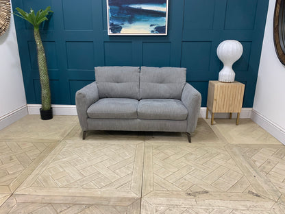 Side profile of the Sofology Mimi 2 seater sofa showing its low-to-the-ground, sleek silhouette.