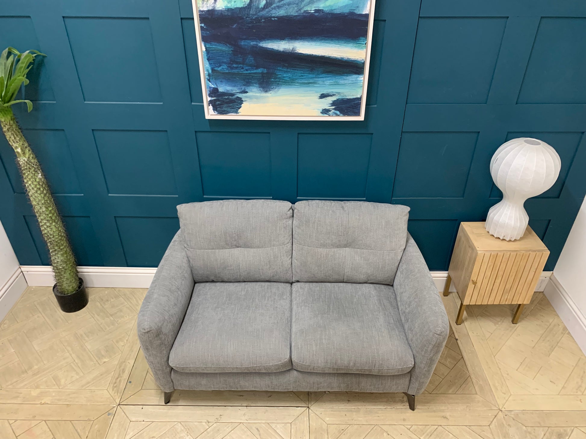 Side profile of the Sofology Mimi 2 seater sofa showing its low-to-the-ground, sleek silhouette.