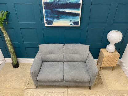 Side profile of the Sofology Mimi 2 seater sofa showing its low-to-the-ground, sleek silhouette.