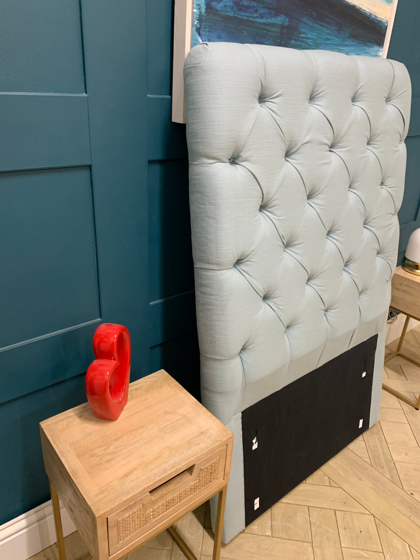 Single Loaf Pillow Talker headboard in light blue fabric with a softly padded squish and curved edges.
