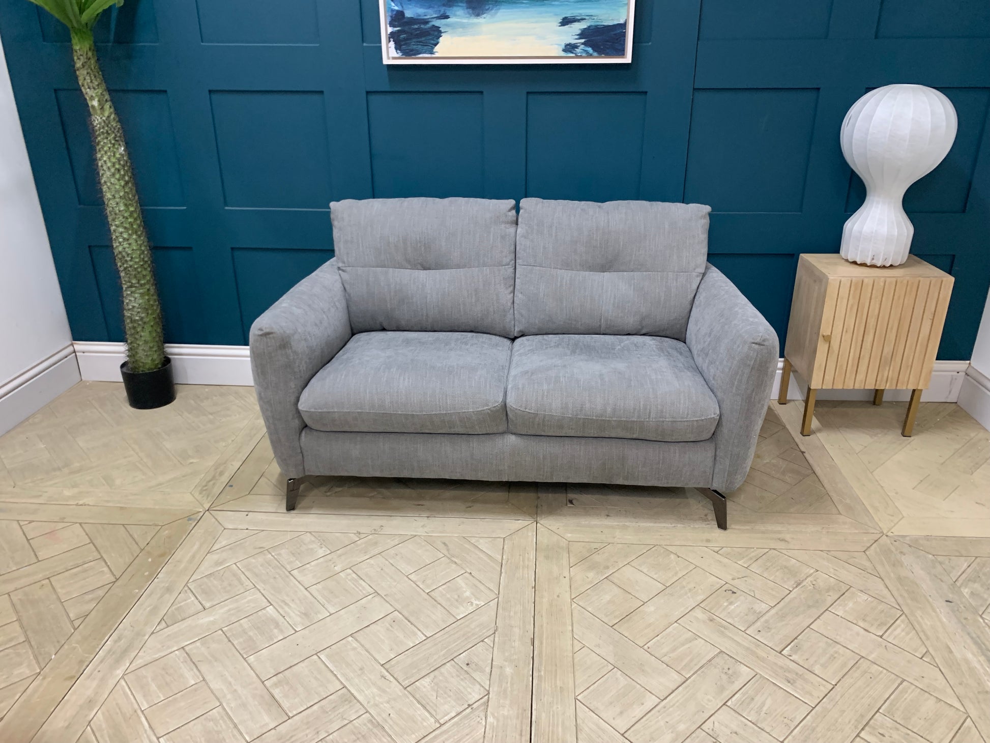 A two-seater Sofology Mimi grey mix cross weave fabric sofa, displayed fr a cozy living room 