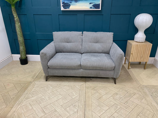 A two-seater Sofology Mimi grey mix cross weave fabric sofa, displayed fr a cozy living room 