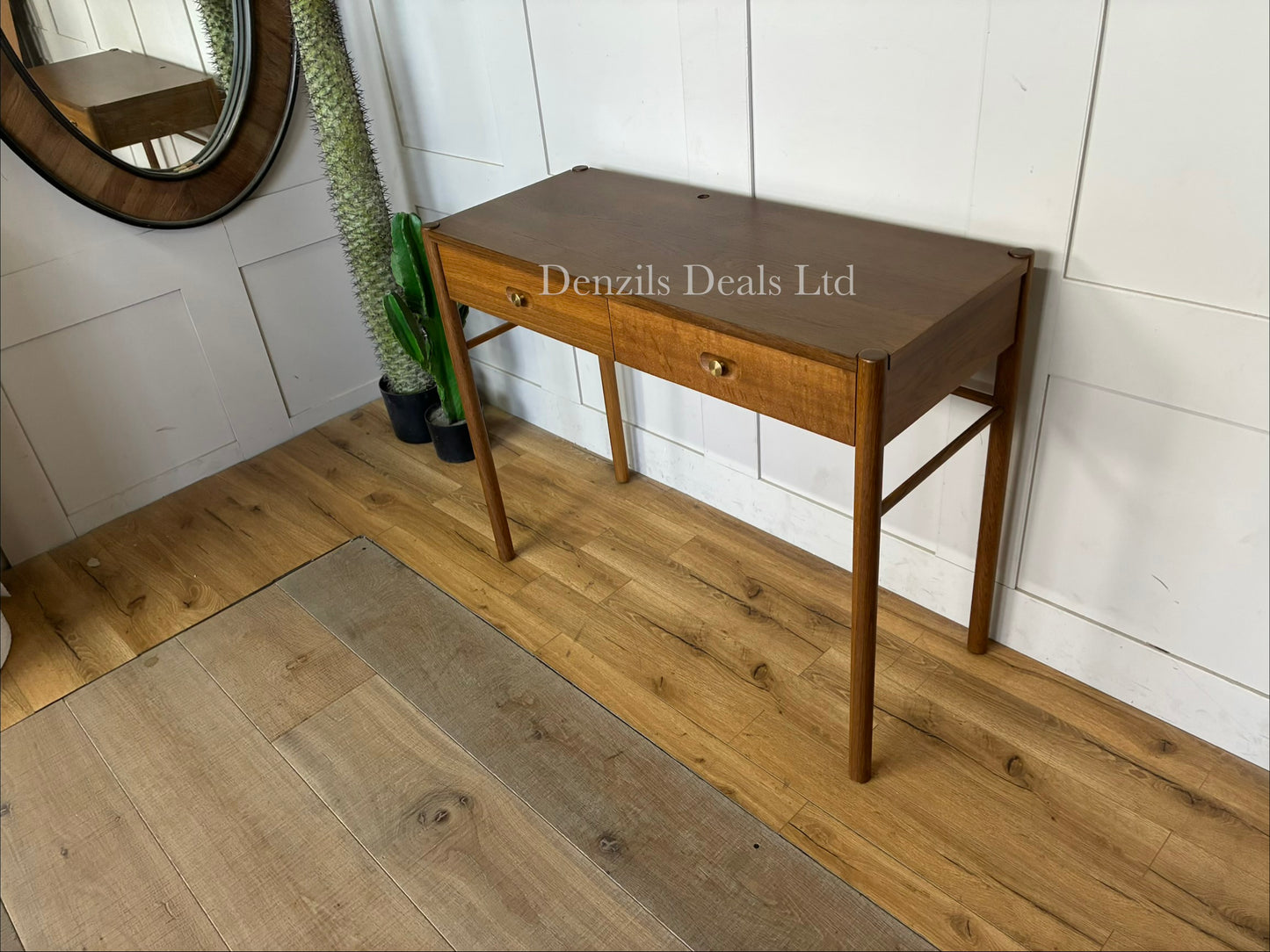 Solid oak Anthropologie Bernadette vanity with an attached round mirror and brass hardware. Dressing table