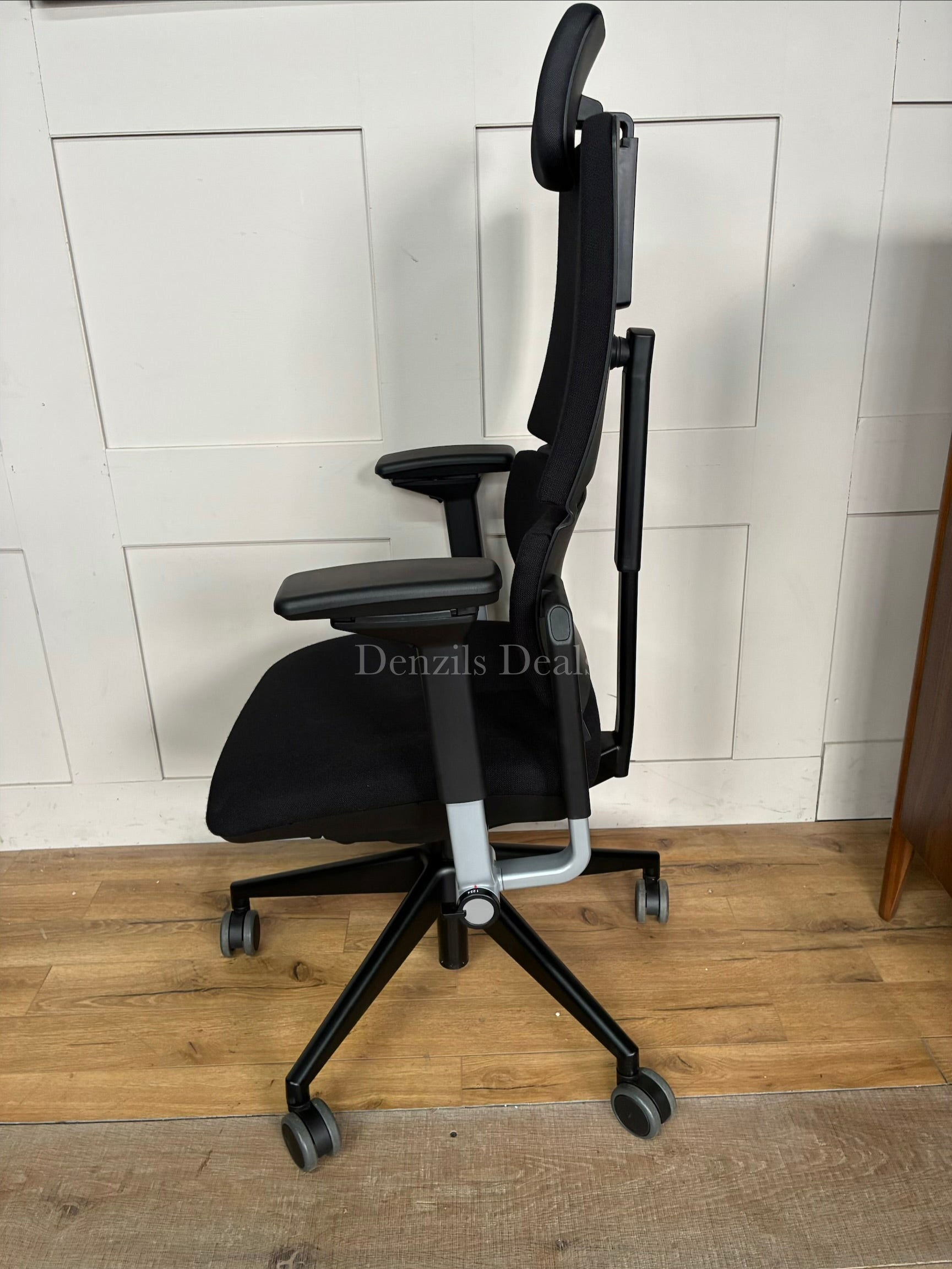 Black Steelcase Please ergonomic desk chair with a headrest.