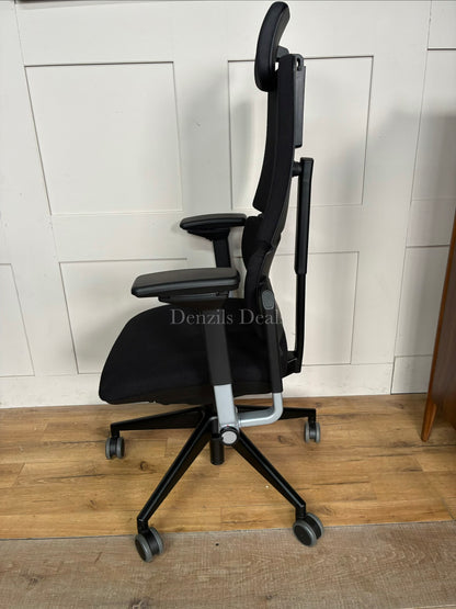 Black Steelcase Please ergonomic desk chair with a headrest.