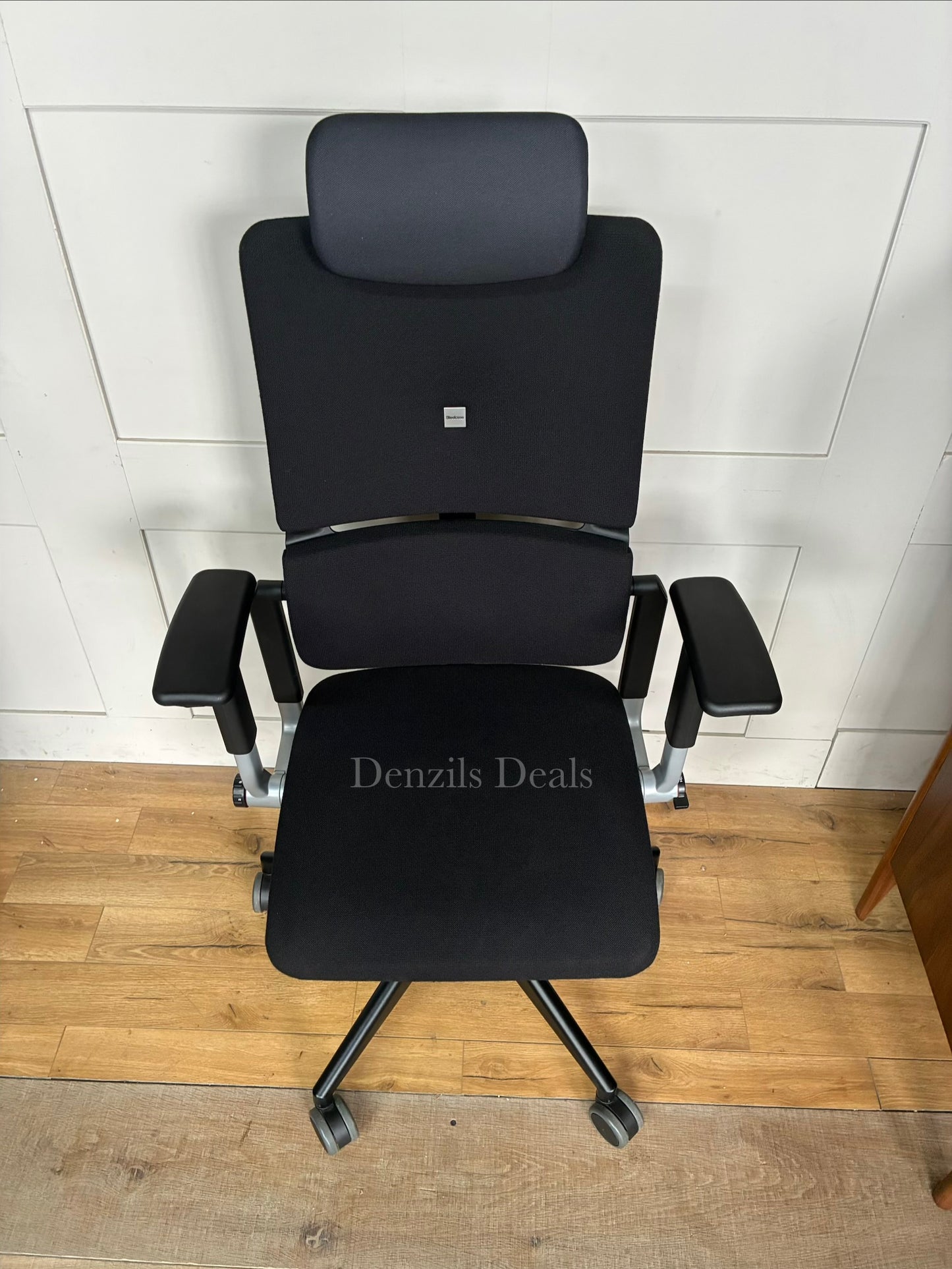 Steelcase Please ergonomic office chair in black fabric with an adjustable headrest.