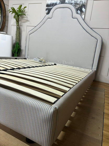 DFS Upholstered super king bed frame in a vibrant Joules hand-drawn blue ticking stripe  fabric with a dramatic tall headboard and sleek dark wood carved feet