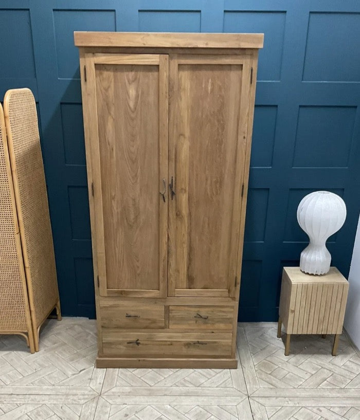 Tall natural teak wood wardrobe with full-length doors and three spacious base drawers, featuring a warm wood grain finish.