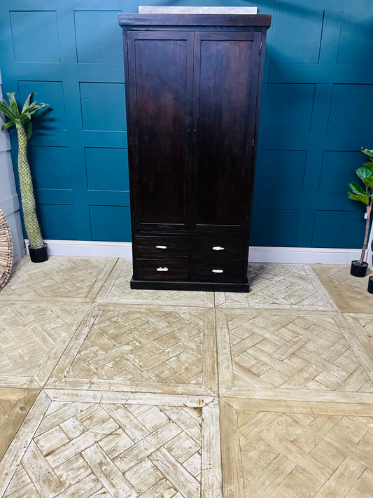 Tall natural teak wood wardrobe with full-length doors and three spacious base drawers, featuring a warm wood grain finish