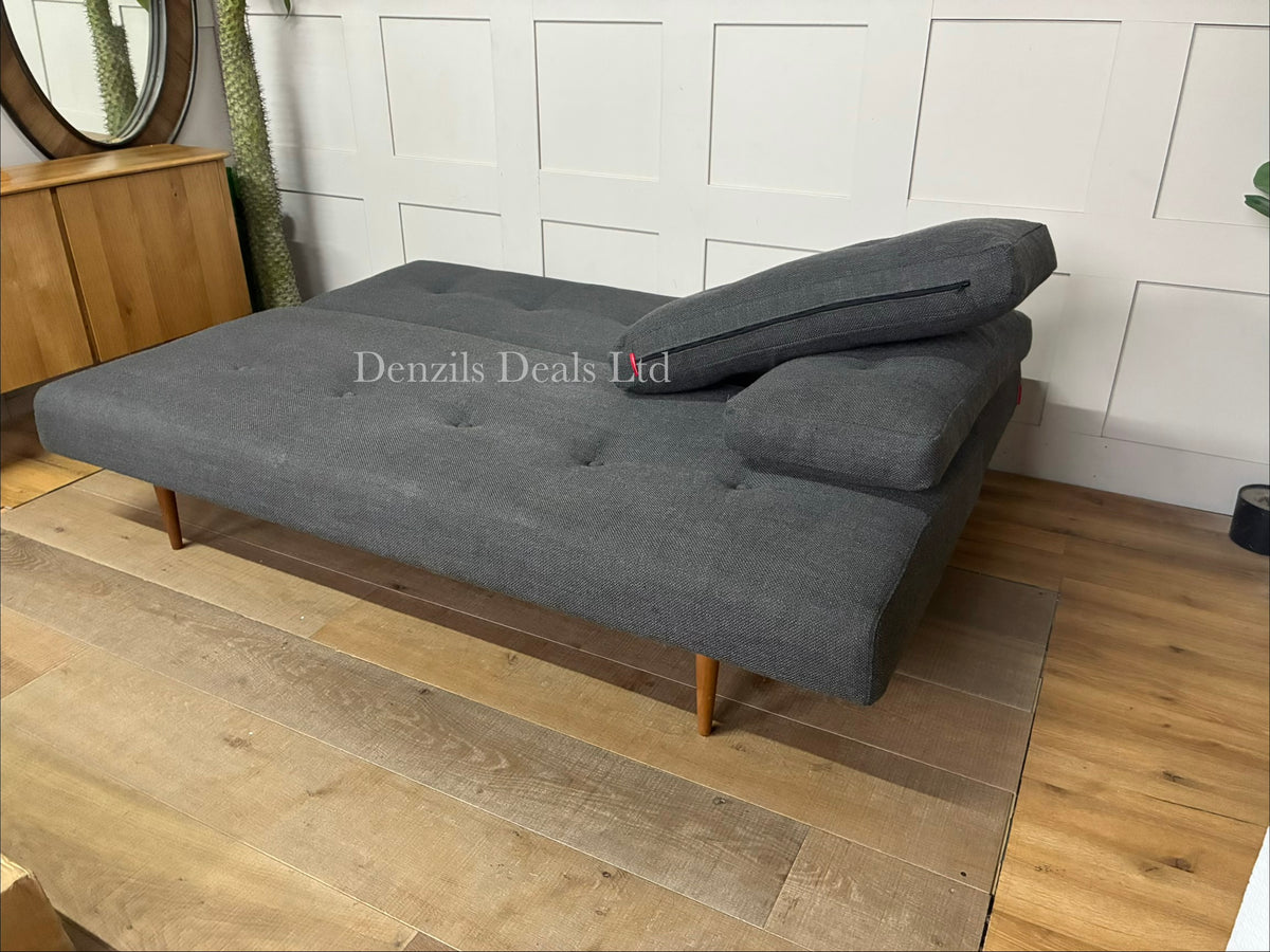 The Innovation Living Recast sofa bed shown converted into a double bed, revealing the 140x200cm pocket sprung mattress layout resting on a steel frame with dark wooden legs.