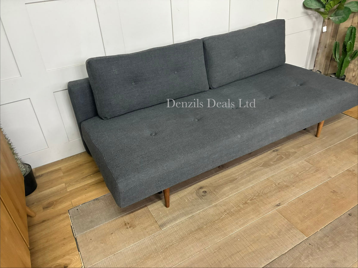 The Innovation Living Recast sofa bed shown converted into a double bed, revealing the 140x200cm pocket sprung mattress layout resting on a steel frame with dark wooden legs.