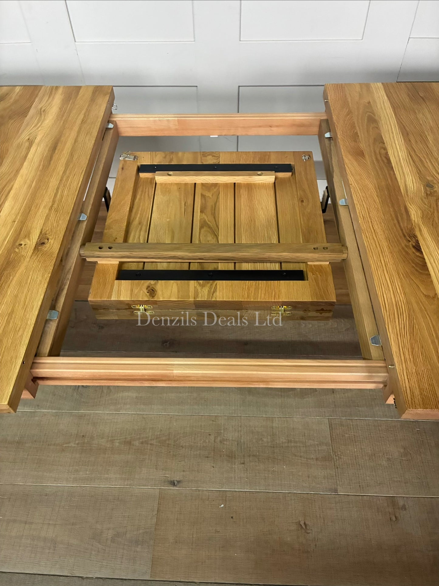 The John Lewis Calia oak dining table showing the extension leaf, highlighting the center extension leaf slot."