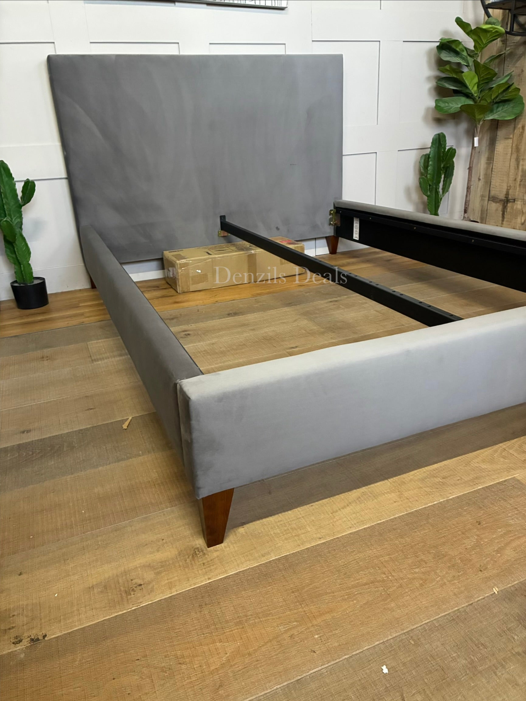 The John Lewis Emily Upholstered Bed Frame in a double size, featuring a padded rectangular headboard and a low-profile base, covered in a soft, textured steel-grey velvet