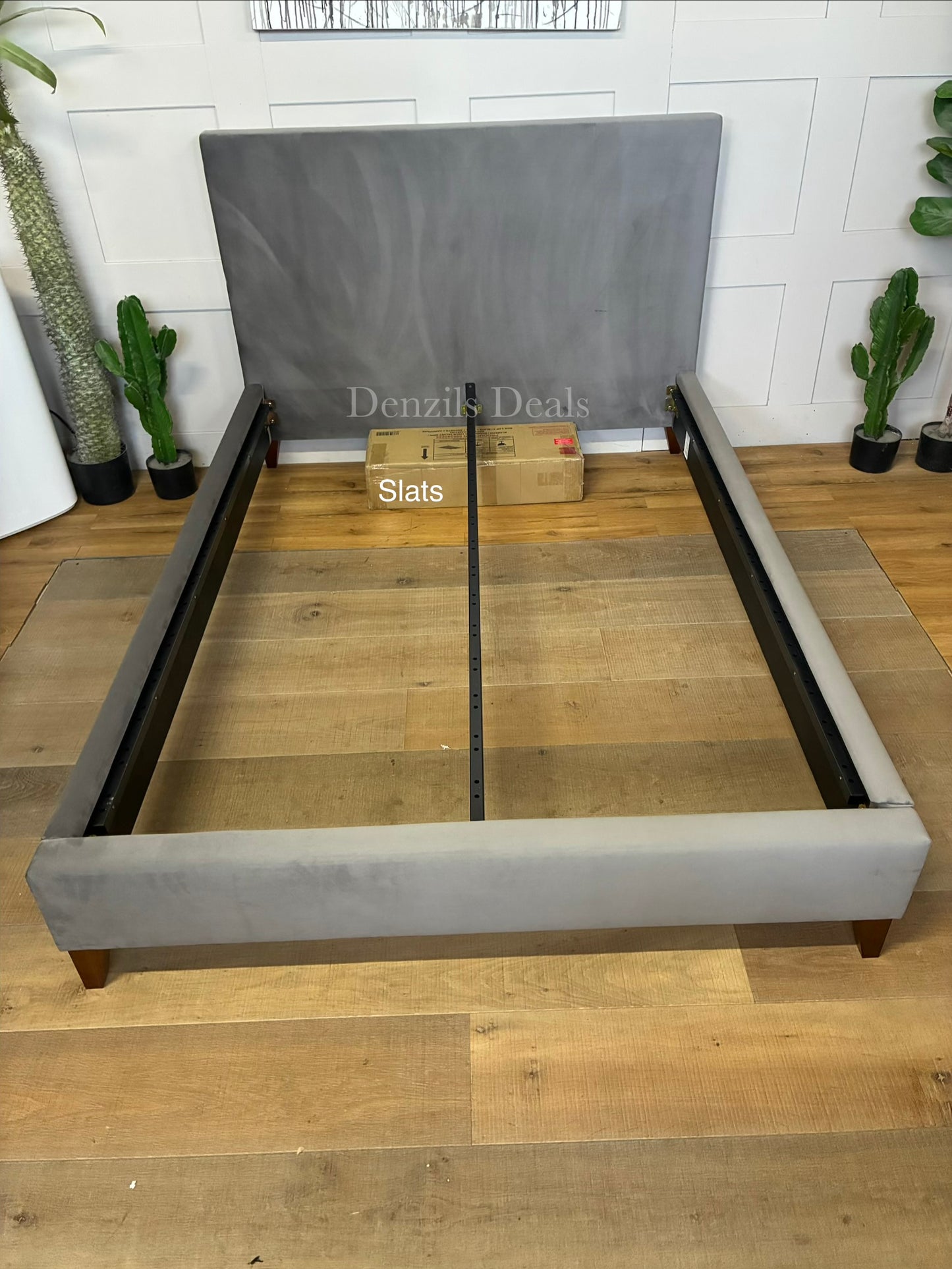The John Lewis Emily Upholstered Bed Frame in a double size, featuring a padded rectangular headboard and a low-profile base, covered in a soft, textured steel-grey velvet