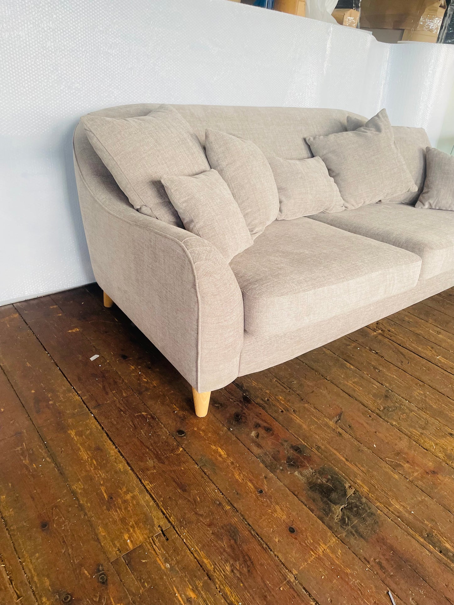 The John Lewis Laze medium 3-seater sofa in Opal Putty, styled in a bright, modern living room with coordinating neutral scatter cushions