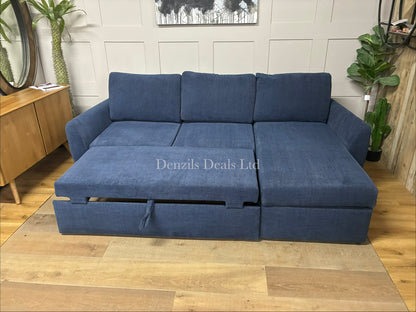 The John Lewis Sansa sofa bed, with hidden storage and fully extended into a large double bed, showing the main section pulled out alongside the stationary chaise section to form a wide, flat foam mattress sleeping area.
