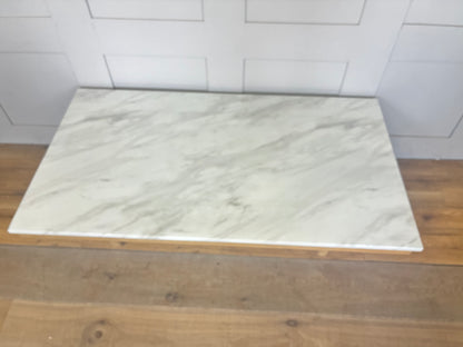 Close-up of the Nick Scali Carlina coffee table, highlighting the natural premium high-density white marble, mitred corner details, and rounded wooden legs."