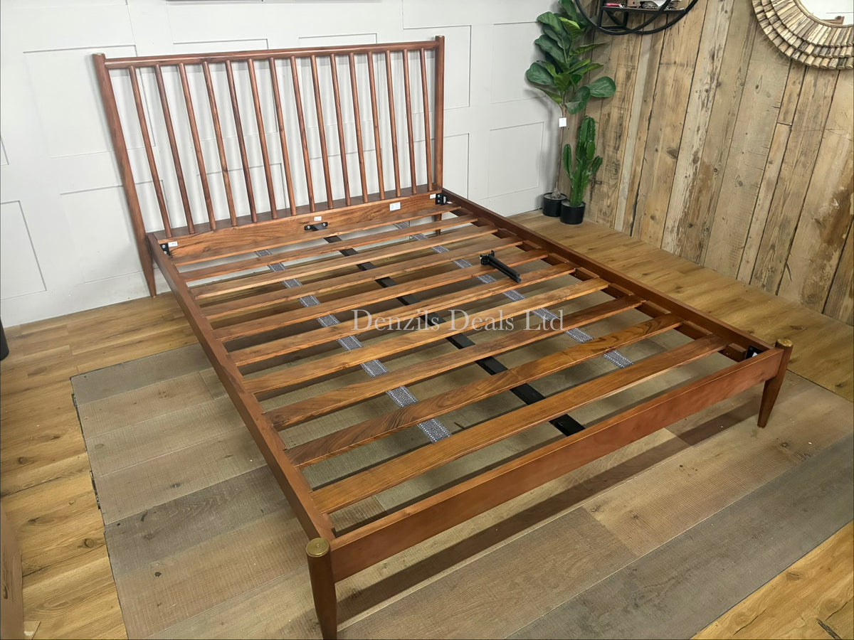 The Swoon Cartwright king-size bed frame in dark brown acacia wood. The bed combines traditional spoked styling with sleek contemporary lines, showcasing a high headboard with clean vertical slats and slim legs.