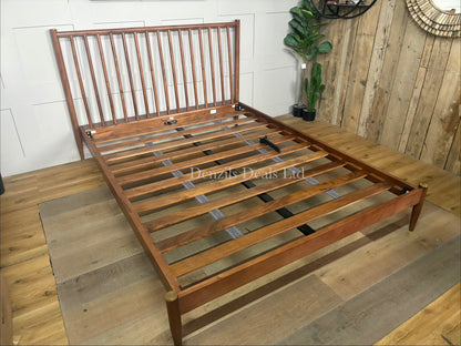 The Swoon Cartwright king-size bed frame in dark brown acacia wood. The bed combines traditional spoked styling with sleek contemporary lines, showcasing a high headboard with clean vertical slats and slim legs.